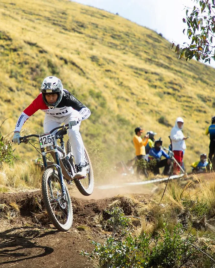 Uneven, dusty terrain highlights the physical and technical demands of the route.