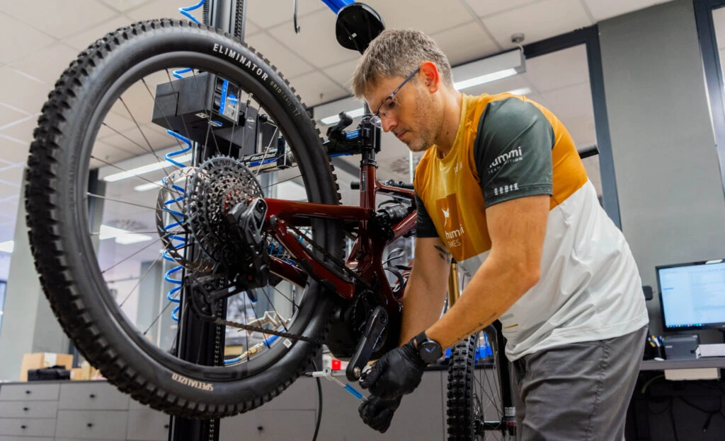 A professional mechanic performs drivetrain and brake adjustments to ensure peak performance on Cusco's most technical trails