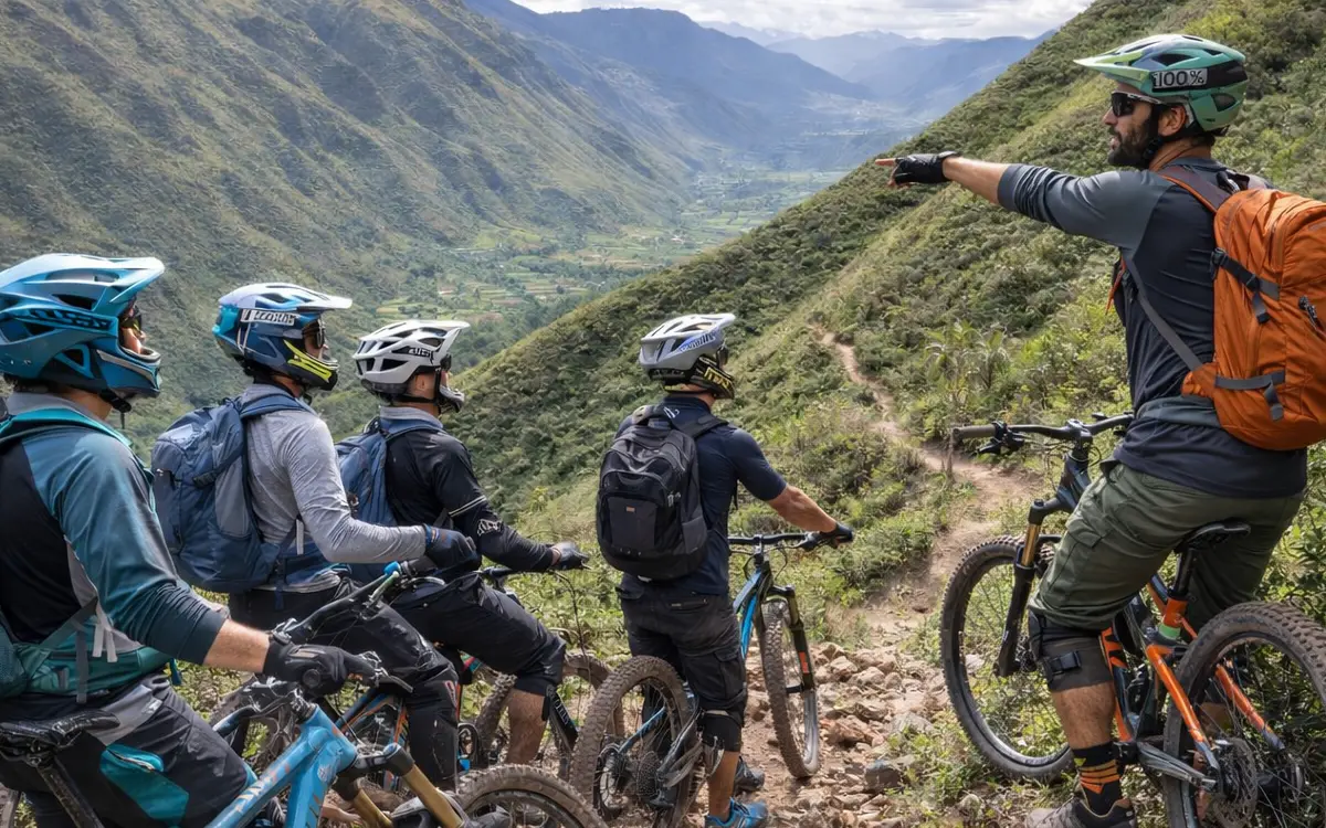 Enduro guide leads a group of mountain bikers on a technical descent in Lamay, Sacred Valley, Cusco, Peru, with wide Andean mountains behind.