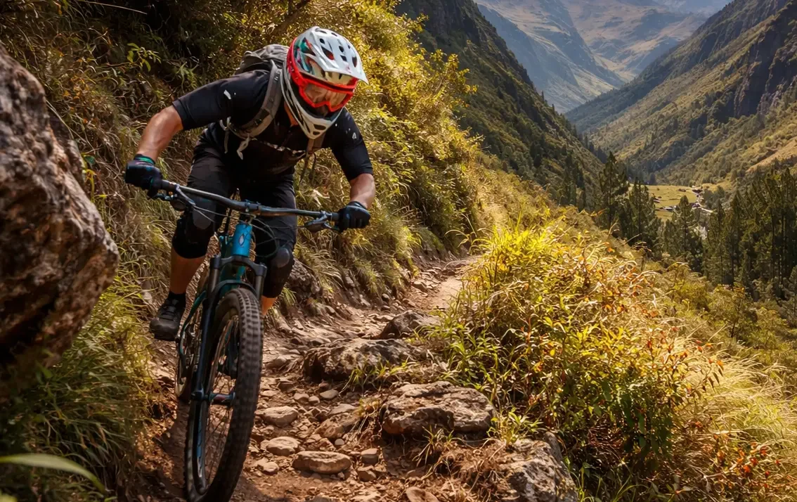 Mountain biker dropping a rocky step section on a steep hillside trail, riding low and steady for maximum control.