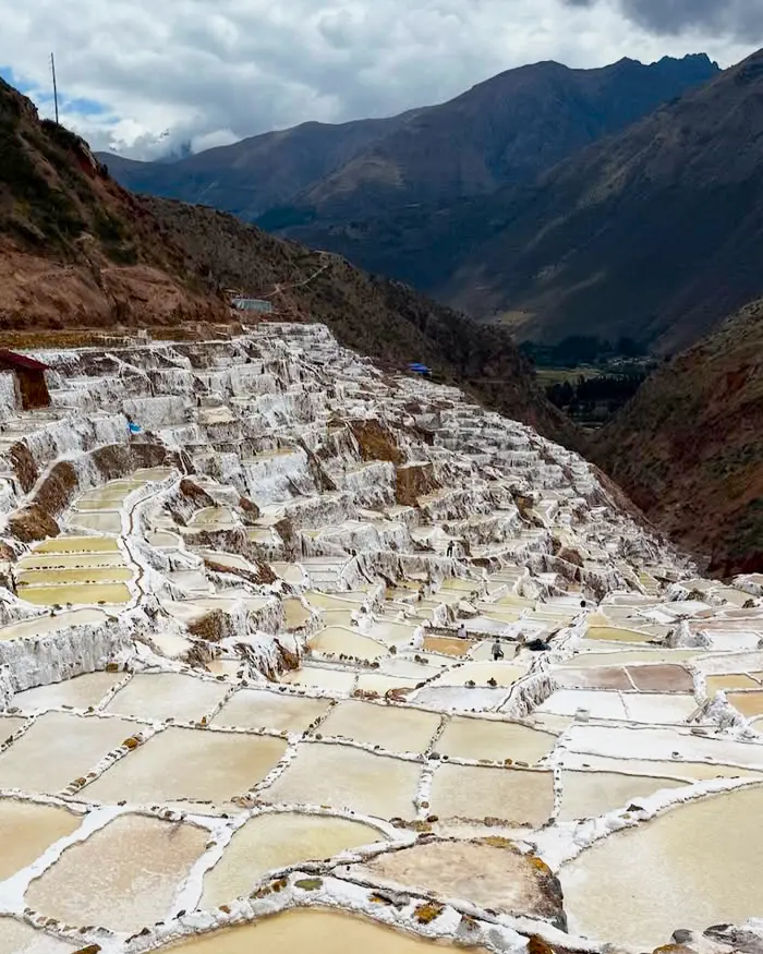 The Maras salt ponds stretch across white terraces that cover the mountainside with hundreds of geometric pools.