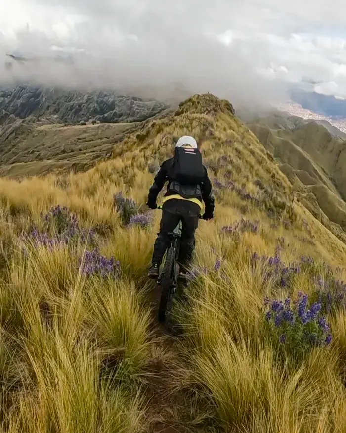 The mountains and deep valleys in the background highlight the extreme elevation of the route.