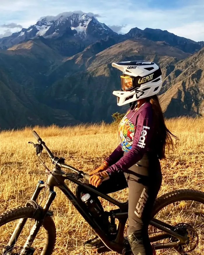 The rider is wearing a full face helmet and technical gear, ready to take on demanding high altitude trails.