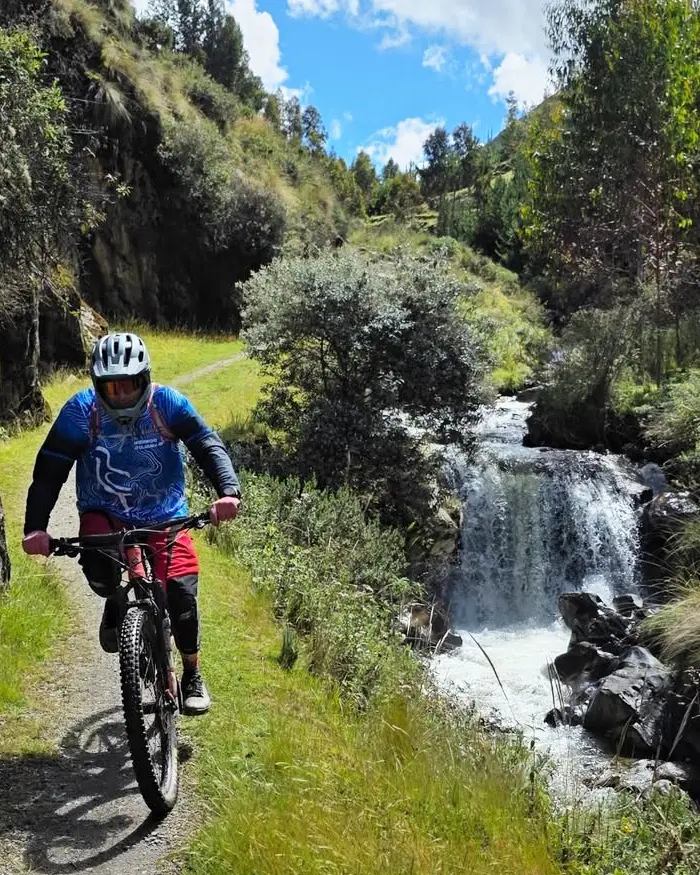 The rider is wearing a helmet and technical gear, ready to handle variable and demanding terrain.